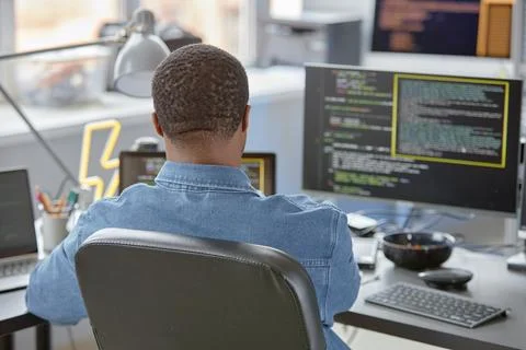 Back View of Male IT Developer in Chair Stock Photos