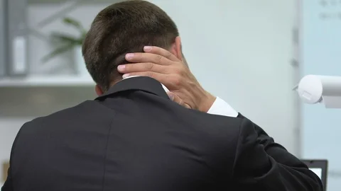 Back view of male office worker massaging painful neck, sedentary lifestyle Stockbeeldmateriaal 117380242
