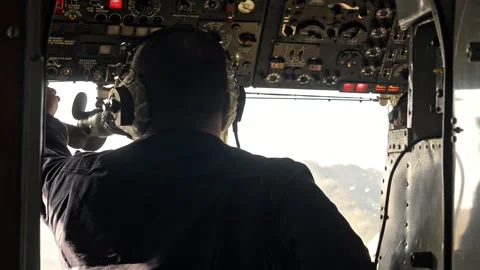 Back view of male pilot aviating helicopter and sitting in cockpit during flight Stock Footage 158994831