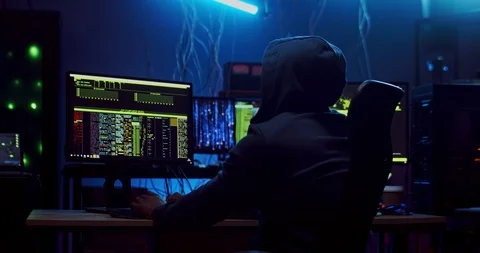 Back view on the male software developer in hood working over hacking programs Stock Footage 124347527