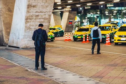Back view of man in black with backpack waiting taxi transports near city r.. Stock Photos