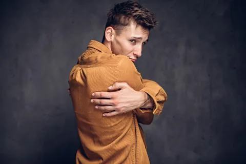 Back view of man clenched hands on dark background Stock Photos
