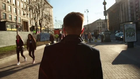 Back view a Man in a Coat walk down the Khreshchatyk and Independence Maidan Stock Footage 80602290