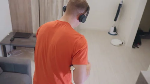 Back View Of Man Dancing With Mop Like Guitar While Cleaning Stock Footage 319915966