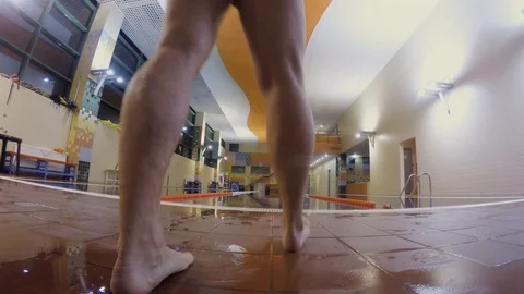 Back view of man diving into swimming pool and swimming the breaststroke. Stock Footage 108182120