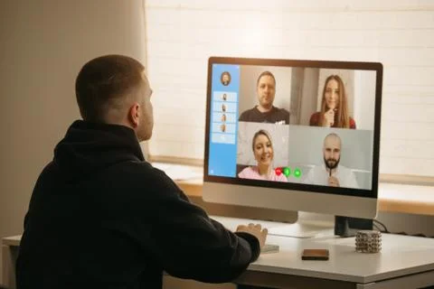 A back view of a man during a video call Stock Photos