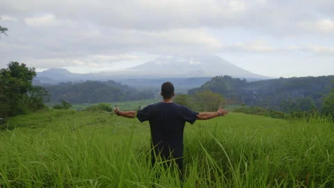 Back View of the Man Enjoying his Journey and Raising Hands. Multiracial Guy on Stock Footage 255569427