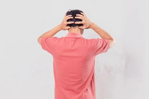 Back view of a man grabbing his head showing stress gesture,on isolated whi.. Stock Photos