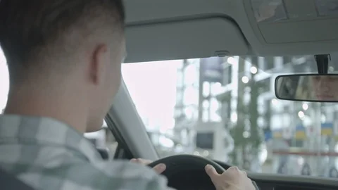 Back view of man in green shirt tasting new car. Stock Footage 99772952