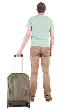 Back view of man with  green suitcase looking up Stock Photos