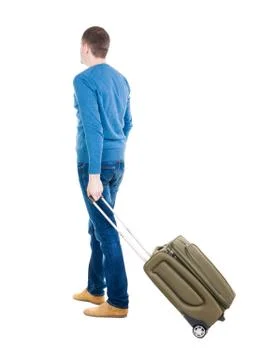 Back view of man with  green suitcase looking up Foto stock