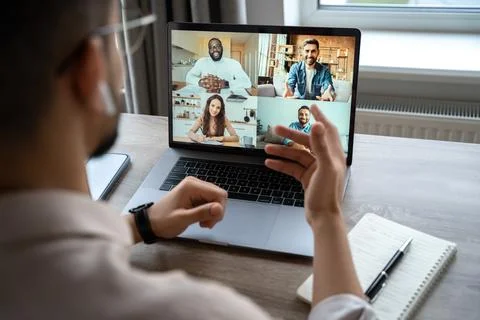 Back view of man having virtual training on video call meeting, online webinar Stock Photos
