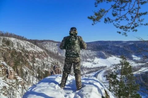 Back view of man hiker at mountain top in winter. Stock Photos