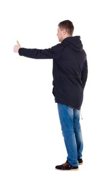 Back view of  man in jacket shows thumbs up Stock Photos