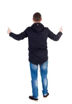 Back view of  man in jacket shows thumbs up Stock-Fotos
