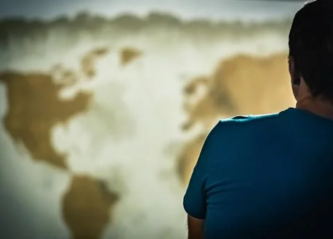 Back view Man looking far away wall world map background. Global isolation Stock Photos