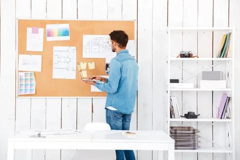 Back view of a man looking at the task board Stock Photos