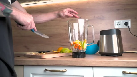 Back view man making fruit smoothie in the morning Stock Footage 209185818
