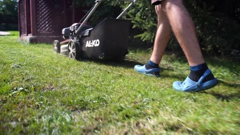 Back view of a man mowing the grass. 11 September 2021, Ternopil, Ukraine Stock Footage 165552820