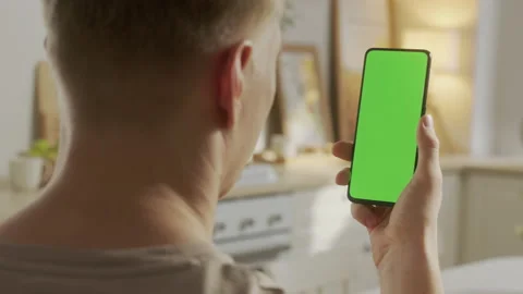 Back View of Man at Phone with Green Screen for Copy Space. Chromakey Mock Up Stock Footage 205575308