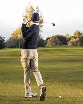 Back view man playing grassy golf field High resolution photo Photos