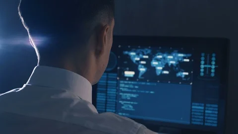 Back view of man programmer in glasses and white shirt working at computer in Stock Footage 106215793