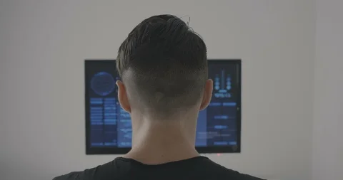 Back view of man programmer working on computer at office Stock Footage 95510759