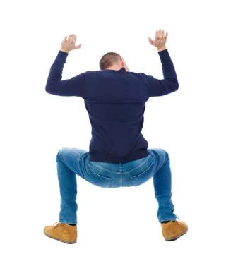 Back view. man  protects hands from what is falling  above Stock-Fotos