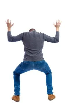 Back view. man  protects hands from what is falling  above Stock Photos