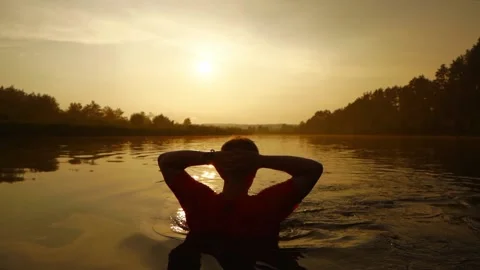 Back view of a man resting in the river Stock Footage 170907912