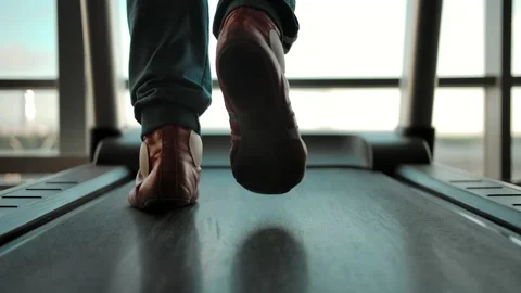 Back view of the man in sneakers walking on a treadmill Stock Footage 139392013