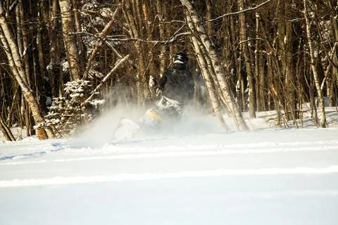Back view of man on snow mobile in field Stock Photos