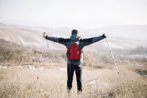Back view of man with spread out hands holding poles Foto stock