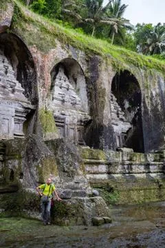 Back view of a man standing alone in front of ancient sacred royal tombs Gunung Stock Photos