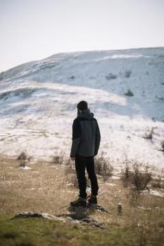 Back view of man standing in front of a snow mountain Stock Photos
