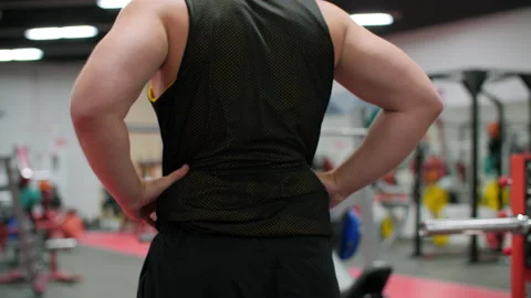 Back view of man stretching muscles before workout in gym Stock Footage 136813415