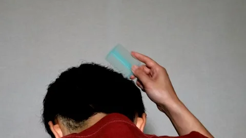 Back view of a man styling his hair Stock Footage 329339938