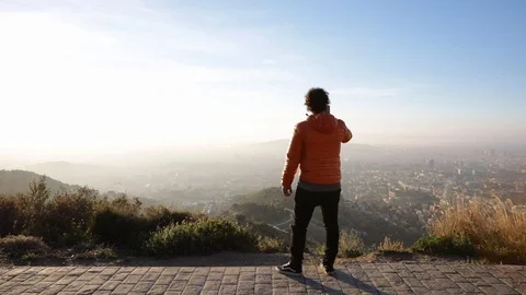 Back view of a man taking pictures at sunrise Stock Footage 104123606