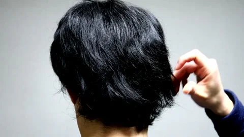 The back view of a man touching his hair. Video stock 336192710