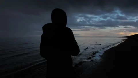 Back view of man walk on the shore of Jurmala, sunset silhouette time, 4k Stock Footage 236958710
