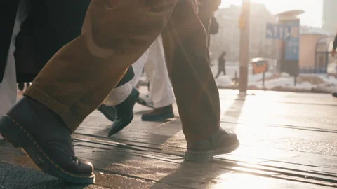 Back view man walking across city street crosswalk. Male feet steps close-up Stock-Footage 326826380