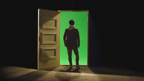 Back view of man walking in front of an open door with green screen . Stranger Stock Footage 232995169
