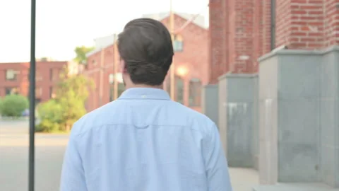 Back View of Man Walking in a Street | Stock Video | Pond5