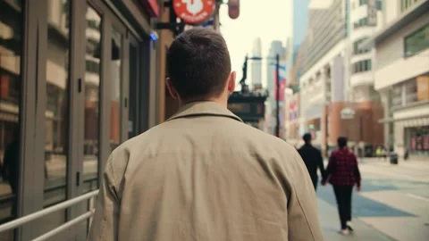 Back view of man walks along the city center street in slow mo.Young guy walking Stock Footage 247297227