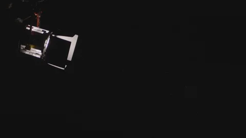 Back View Of A Man Walks Through Studio Light Beam With Scene Of Dust Stock Footage 126922082