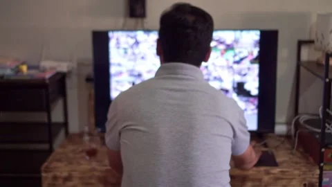 Back view of man watching live security camera feeds on dual screens, Stock Footage 342747989
