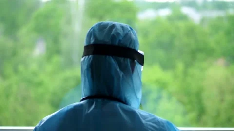 Back view of medical worker in special protective suit. tired and exhausted Stock-Footage 131064828
