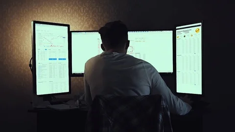 Back view of modern programmer sitting and writing code in dark room. Stock Stock Footage 90732344