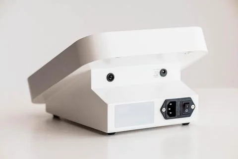 Back View of Modern White Electronic Device with Power Switch and Connector.. Stock Photos