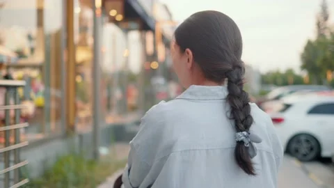 Back view of mom pushing stroller and walking down the street Video stock 201215969